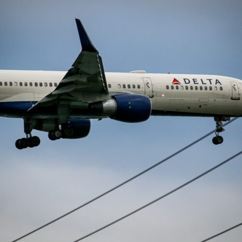 A Delta Airlines airplane getting de-iced on a snowy runway to prepare for a safe flight and avoid winter weather delays