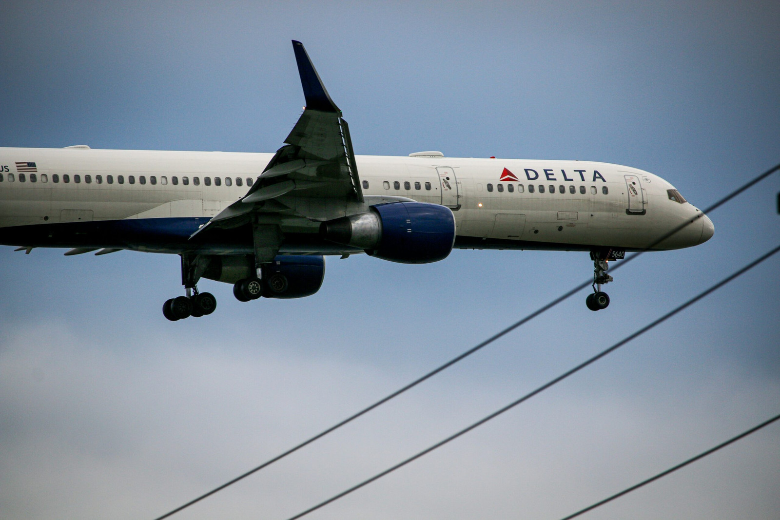 A Delta Airlines airplane getting de-iced on a snowy runway to prepare for a safe flight and avoid winter weather delays